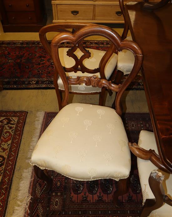 A set of four Victorian rosewood buckle back dining chairs, a.f. and a set of four mahogany balloon back dining chairs
